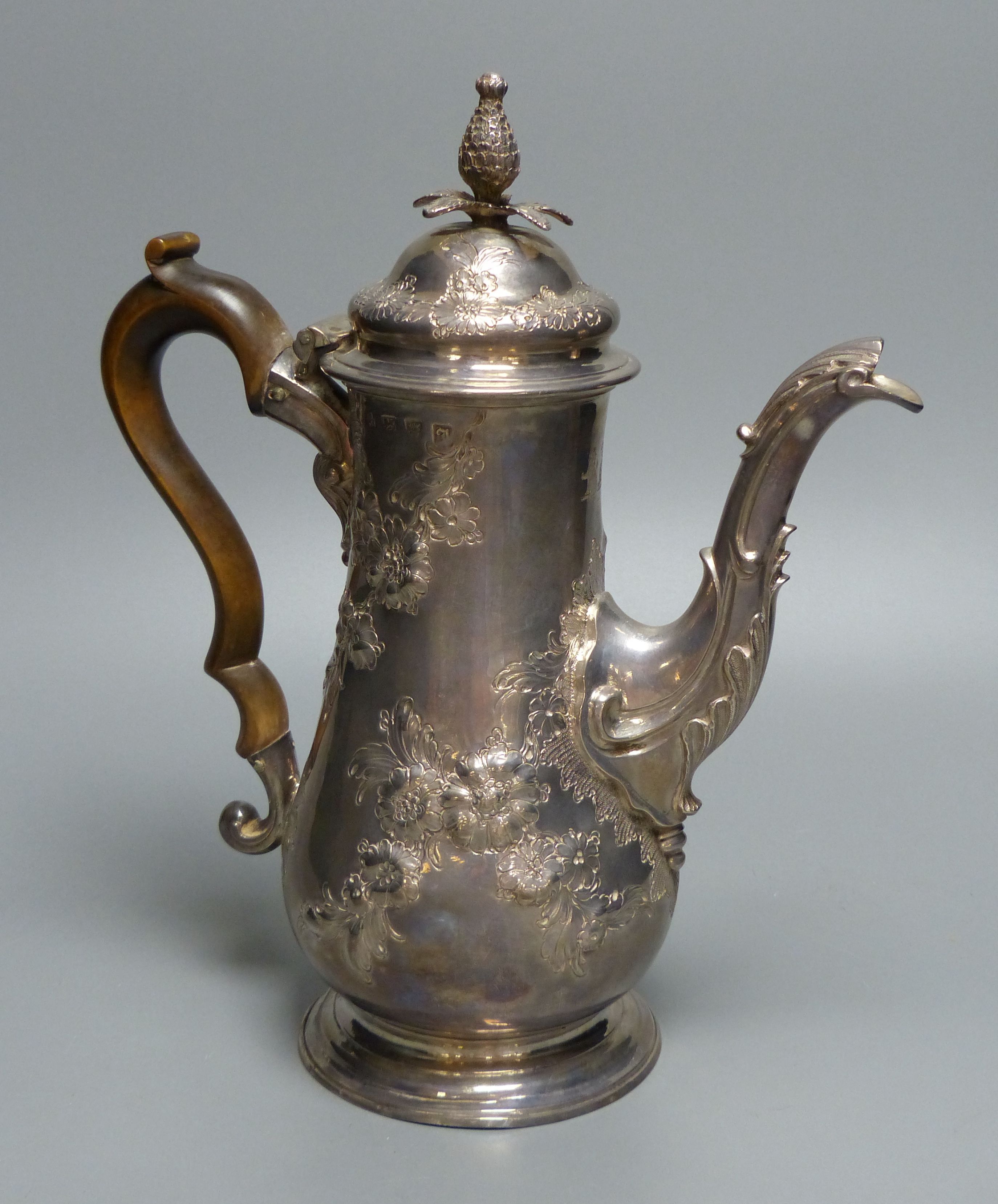 An early George III silver coffee pot, with later embossed decoration, maker ?D over WI,